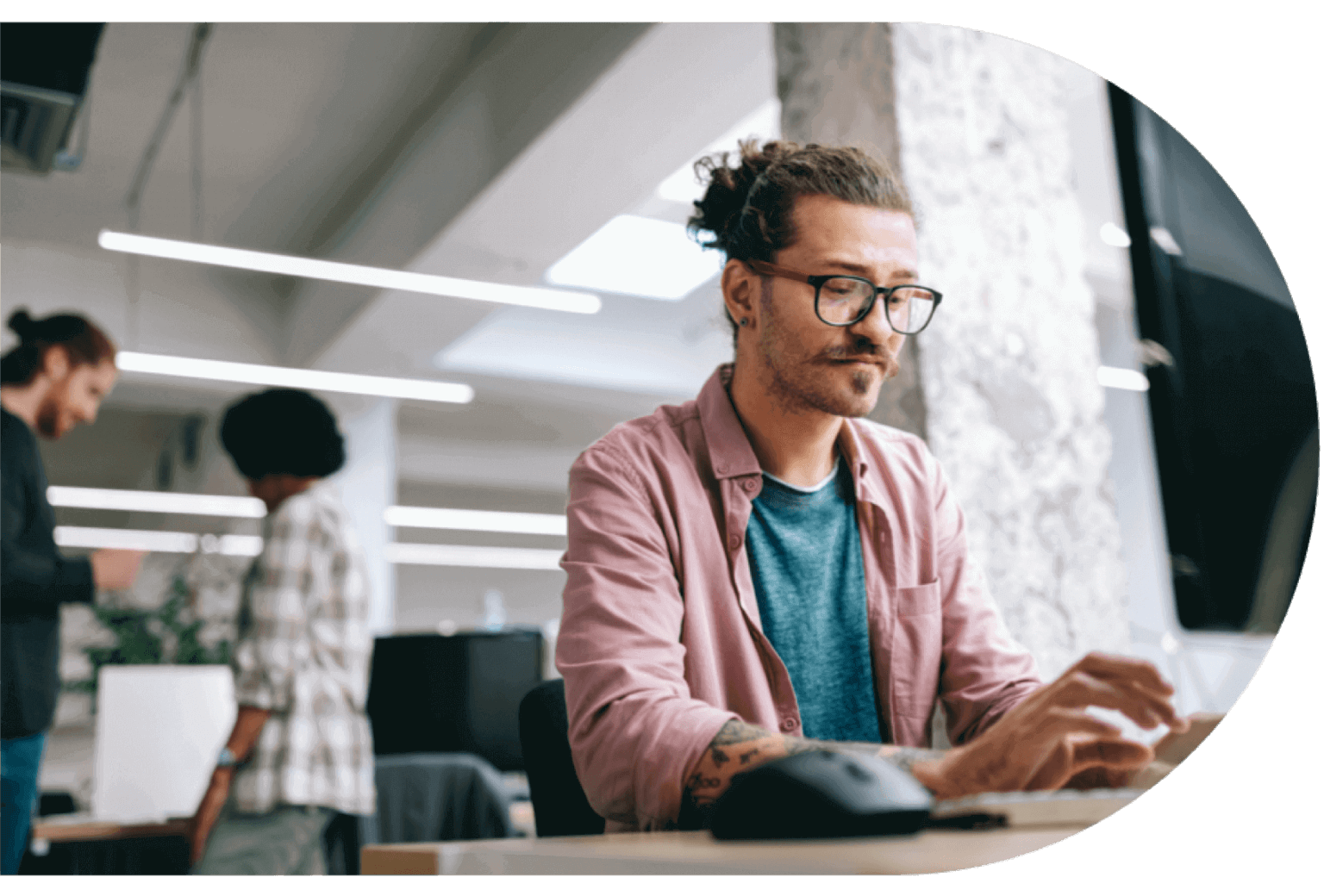 Man sits at his desk working on his computer