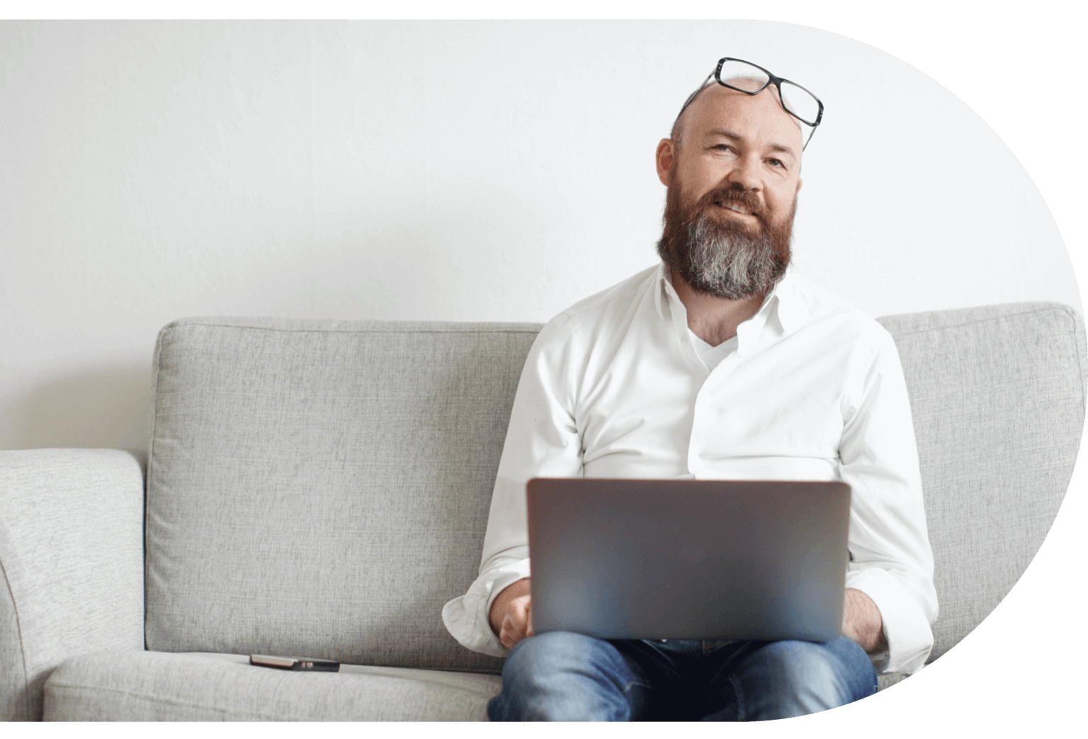 Man sits with a laptop on his lap