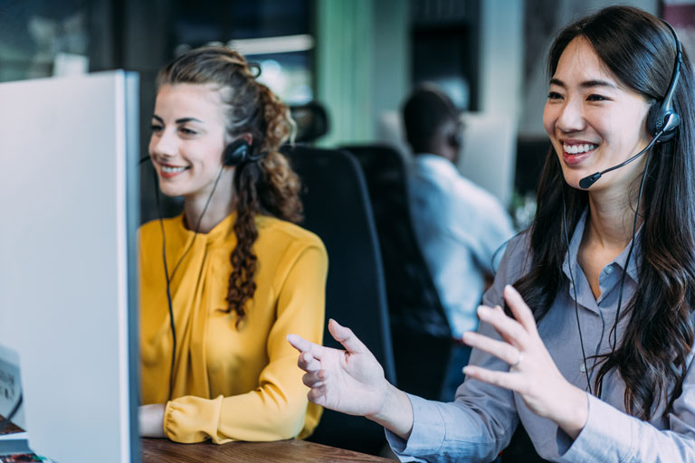 Two female customer experience experts