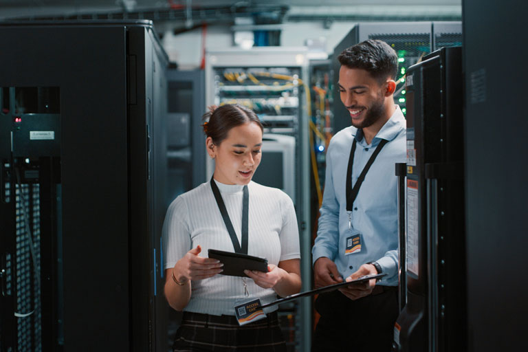 Two IT professionals in a server room